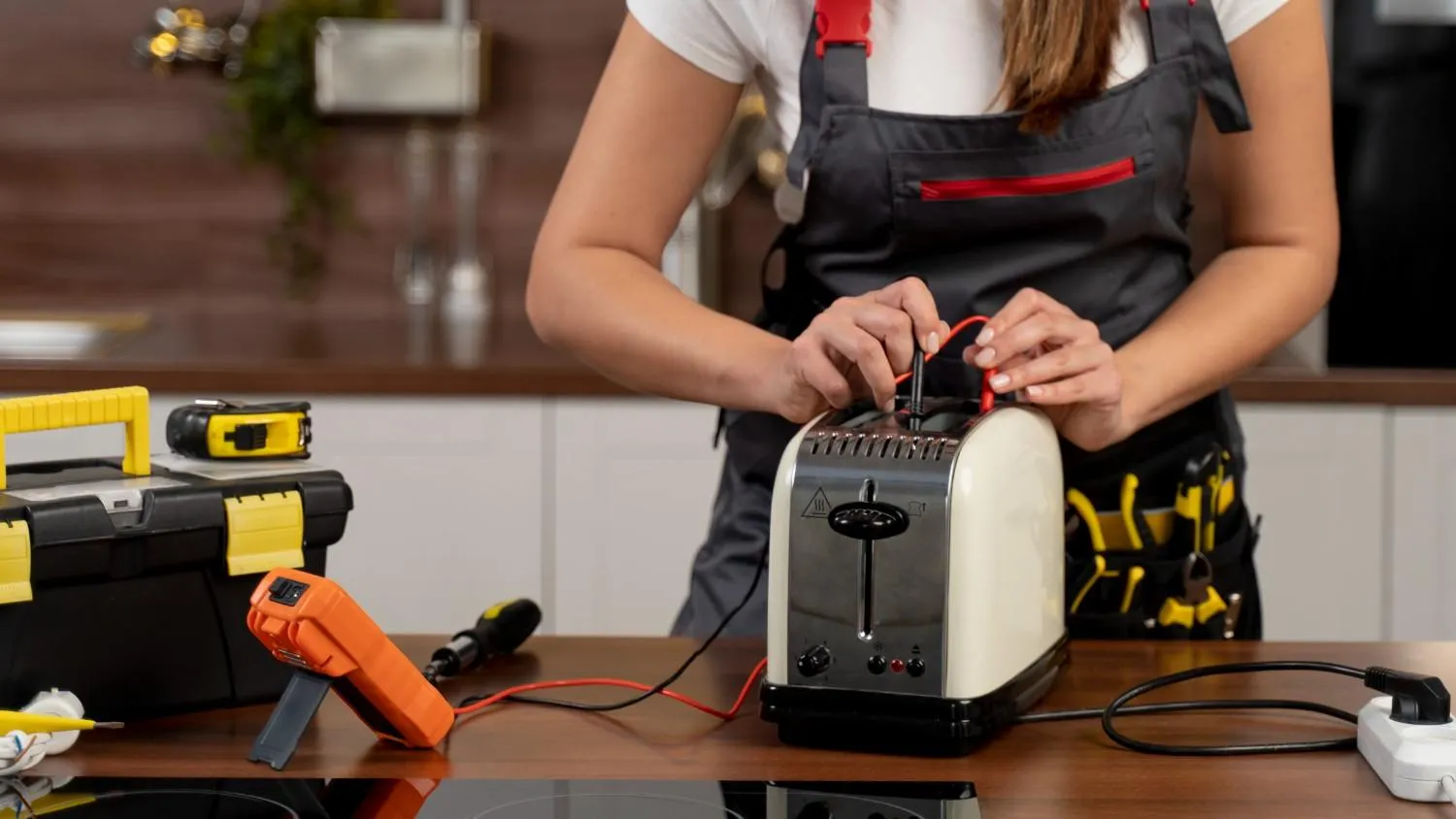 Contractor testing a kitchen appliance with a meter